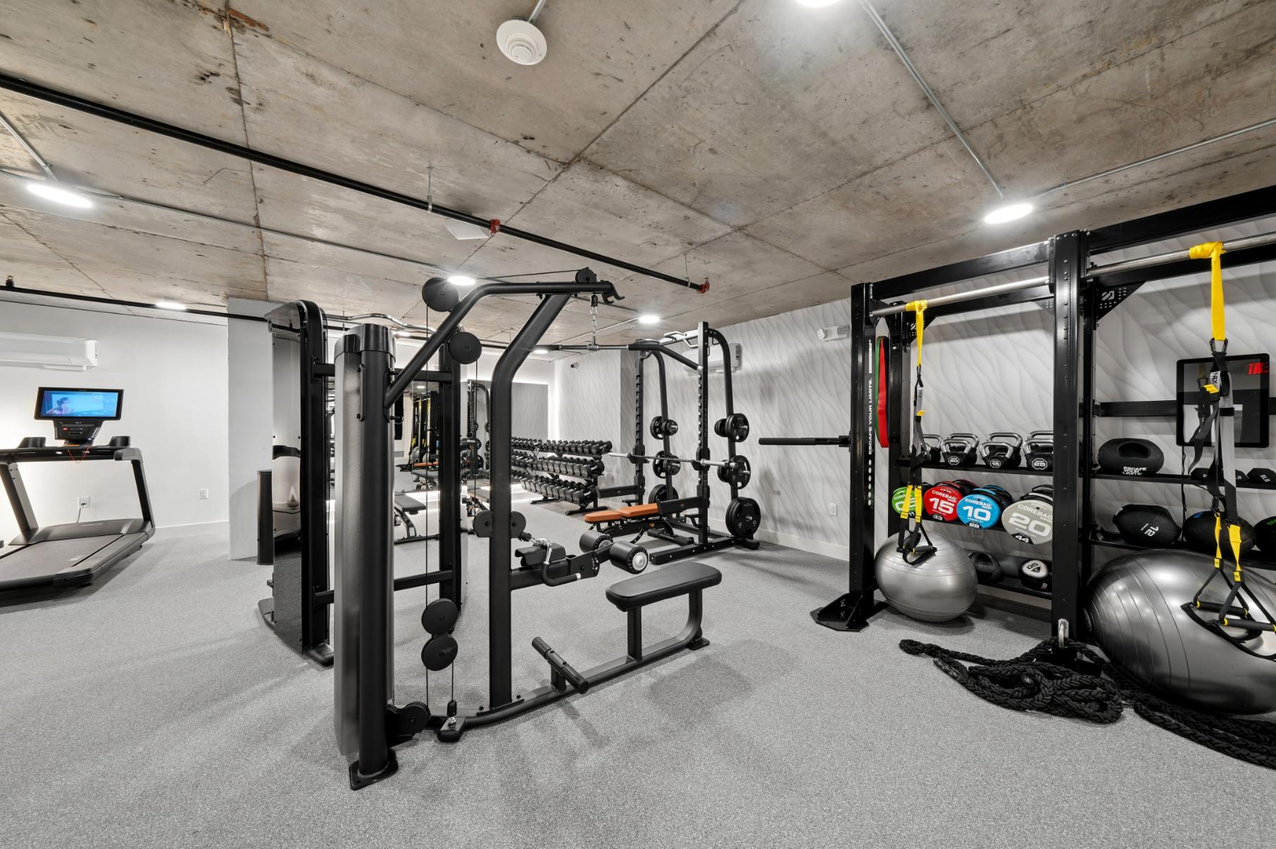 Fitness center showing free weights and training machines